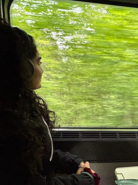 Woman looking out train window